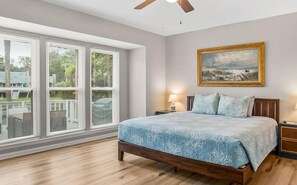 Master bedroom with scenic views of the tranquil pond.