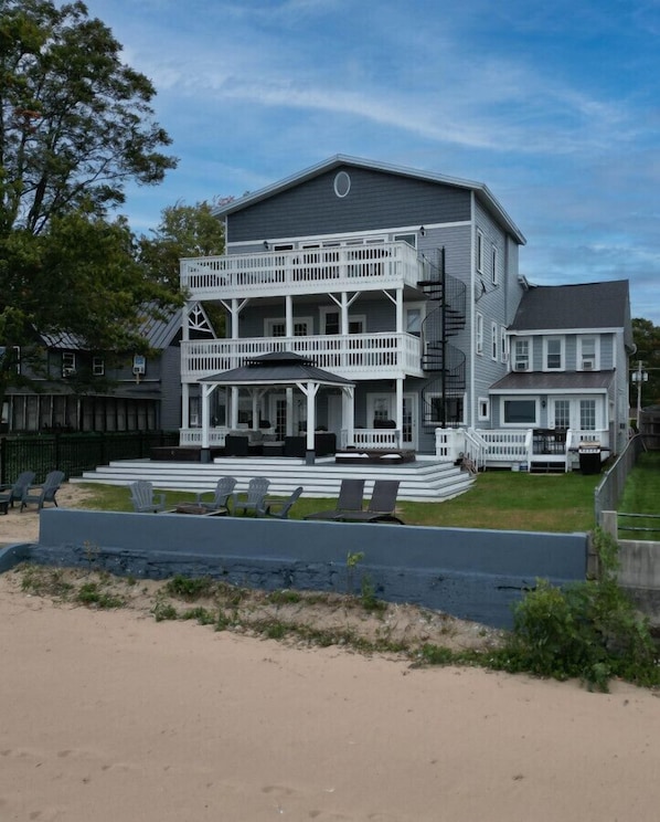 A beachfront paradise with a large house with plenty of decks, perfect for enjoying the sun, sand, and sea.