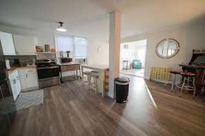 A dream kitchen with stainless steel appliances, and white cabinets, perfect for cooking and entertaining guests.