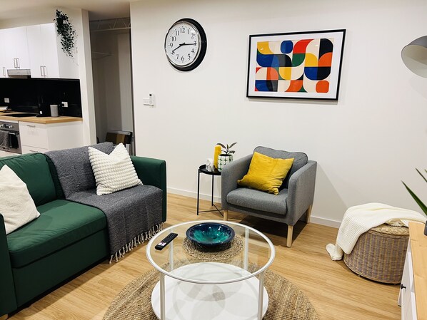 Comfy and stylish sitting area. Coffee table and art books for reading. 
