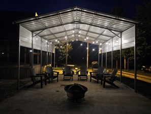 Covered Patio with Fire Pit, Adirondack Chairs, Picnic Table, Grill & Firewood