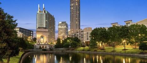 Beautiful nighttime view of city and pond in front of the complex! 