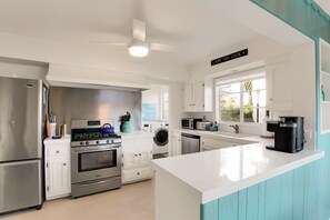 Villa 1- Newly refreshed kitchen with quartz countertops and full sized washer/dryer