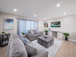 Living room with Smart TV and comfortable designer furnishings