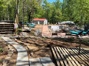 View of pavilion from yoga hut. Pool ready late May 2024