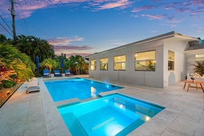 Bask in the sunshine by the recently constructed heated pool and inviting hot tub