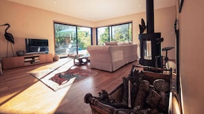 Living room with large corner sofa - Large TV - Wood-burning stove (wood supplied).