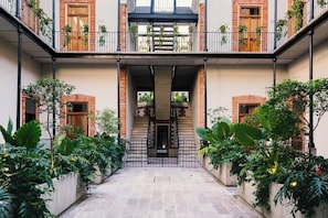Enjoy lazy mornings with our charming French cafe in the building's main "patio", surrounded by beautiful and vibrant gardens that elevate your mood and enhance your stay.