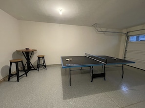 Ping pong game area in garage.