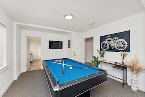 Game room with pool table and tv