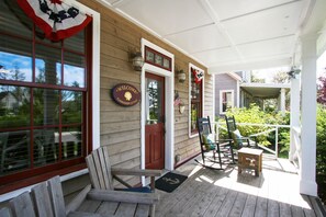 Relax on the spacious front porch in a rocking chair and visit with neighbors