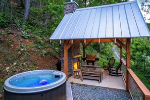 Hot Tub located near Outdoor Pavilion with wood burning Fireplace