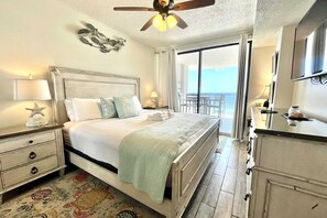 Primary bedroom includes a comfy king-sized bed and direct access to the balcony!