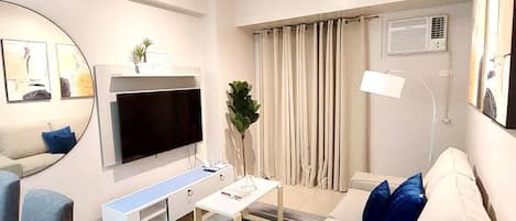 A minimalist living room, tastefully design with a cozy sofa, coffee table
