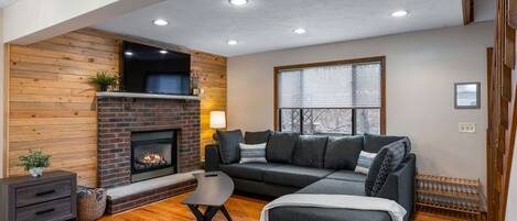 Living room with sectional sofa, Ultra HD Smart TV and gas fireplace