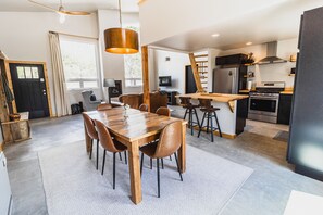 Open dining area with wooden table...