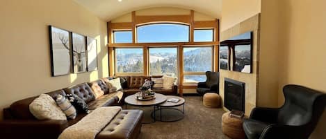 Cozy up near the fireplace in this main living room