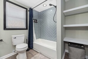 Primary Bathroom with double vanity, tub and shower