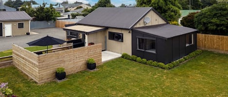 Aerial view of parking behind the house, front yard and outdoor area