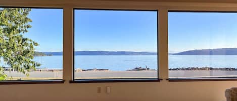 Relax in the living room to this view. Watch the activity on the water as paddle boarders, boaters, paddlers, walkers and cyclists pass by. You will even get a show from the Naval Air Station Whidbey Island (NASWI) which is located in Oak Harbor.