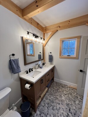 Primary bathroom with a shower and double vanity.