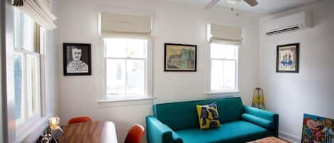 Local art prints, famous authors prints, and original art adorn the walls of this bright and comfortable apartment.