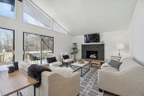 Open the sliders to the expansive elevated deck. (Fireplace is for decoration).