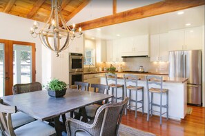 Kitchen dining table, seats six with wood burning fireplace.