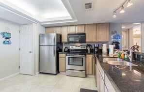 Kitchen stocked with pots, pans, dishes, and all the things for entertaining.