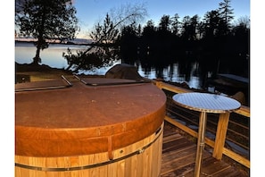 Private hot tub, and grilling area to enjoy a relaxing evening overlooking lake!