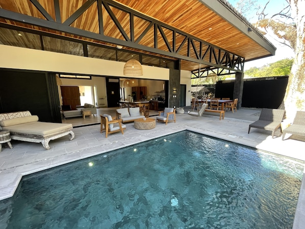 Stone pool overlooks jungle and open to villa 