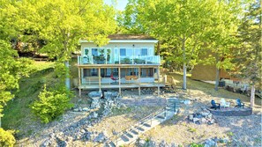 House waterside.  2 Decks and wide gradual concrete stairs with railing to dock.