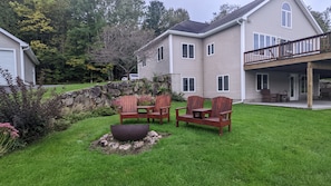 Fire pit with chairs facing the lake.