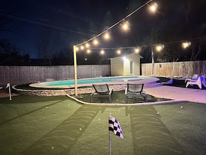 A lot of lights in the backyard. Golf Turf in the backyard