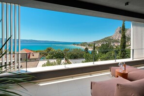 A sun deck area with 4 deck chairs plus a built-in sun deck bench with pillows, an outdoor shower