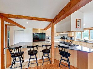 Barstool seating in kitchen area.