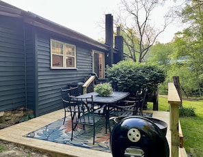 Ground level walk up patio with seating and Weber charcoal grill available. 