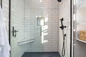 The newly renovated bathroom has a nice stall shower with a hand sprayer. 