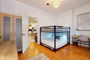 Bedroom 1: Right beside the door, a cabinet provides hanging space for clothes and storage for bags, helping to keep the room organized.