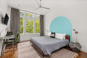 King guest suite with attached bath and desk.