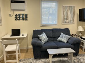 Living room shown with pop-up work space!