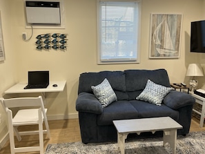 Living room shown with pop-up work space!