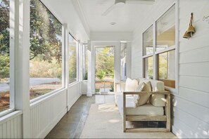 Enter the house through the sunny screened porch