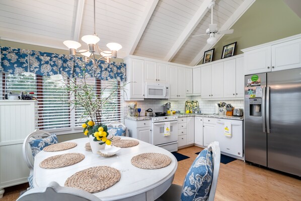 The kitchen has a ship lapped ceiling and large dining area