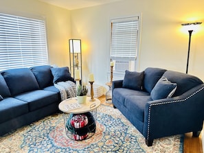 Living room with A/C unit. 