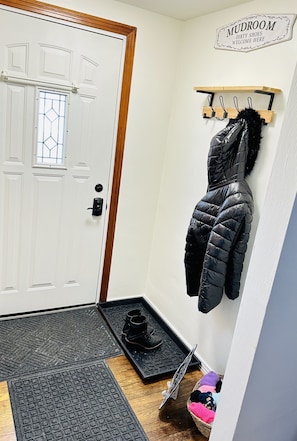 Entryway where you can remove your shoes and put on comfy socks to wear inside.