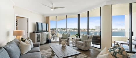 Living Room | Breathe Easy Rentals - Comfortably accommodates 6 to 8 guest on the large cushy sofa and 2 swivel club chairs to take in the gorgeous harbor view or catch up on your fav shows and news with the big screen smart tv.