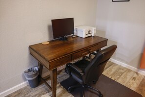 Get working with large desk, executive chair, monitor and printer.