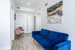 Living room with a sofa and two chairs. The space is bright
