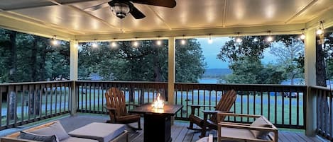 Enjoy the front porch with amazing lake views and propane fire pit!